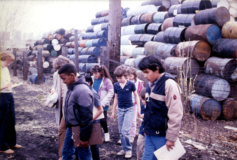 Jackson Elementary School students tour a hazardous waste storage facility located only three blocks from their school. The students successfully lobbied the State legislature to have the toxic dump designated a US EPA Superfund site, slated for cleanup. 
